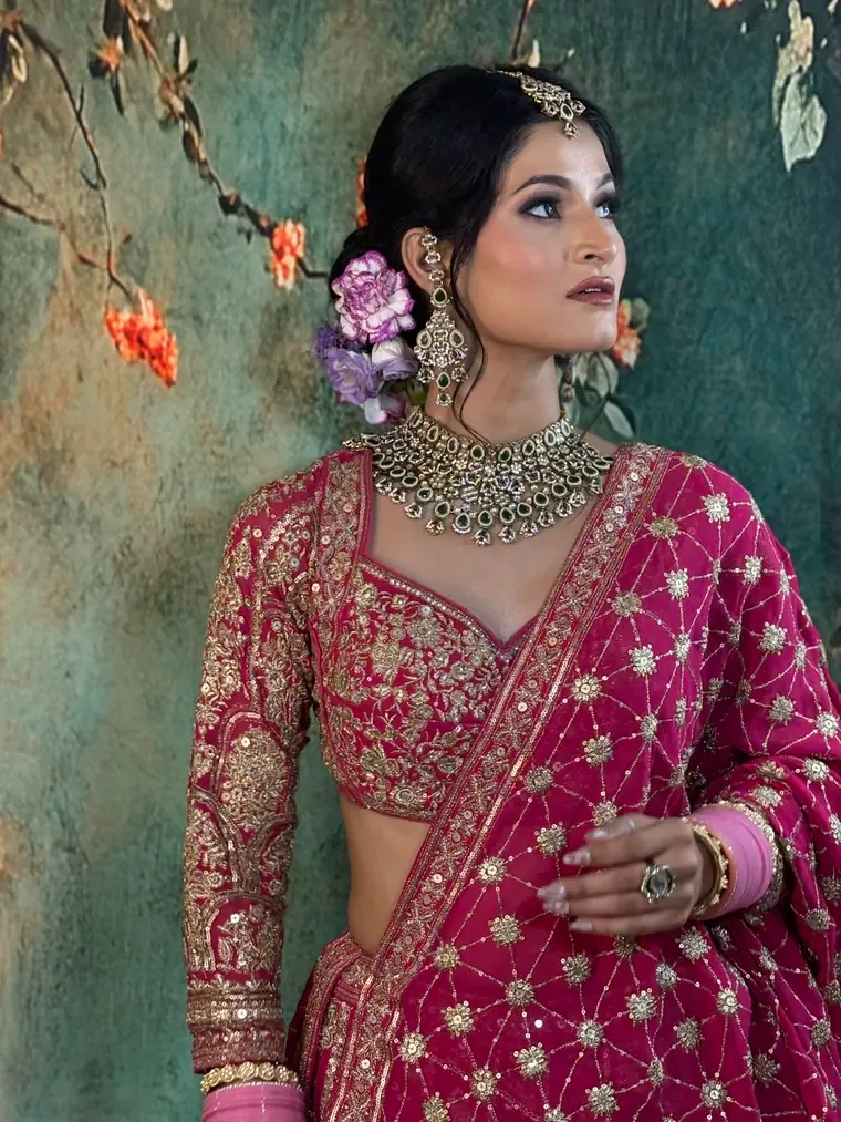Bride in a magenta and gold lehenga with kundan jewellery, full bridal makeup by Manpreet Bhasin's Peaches & Cream